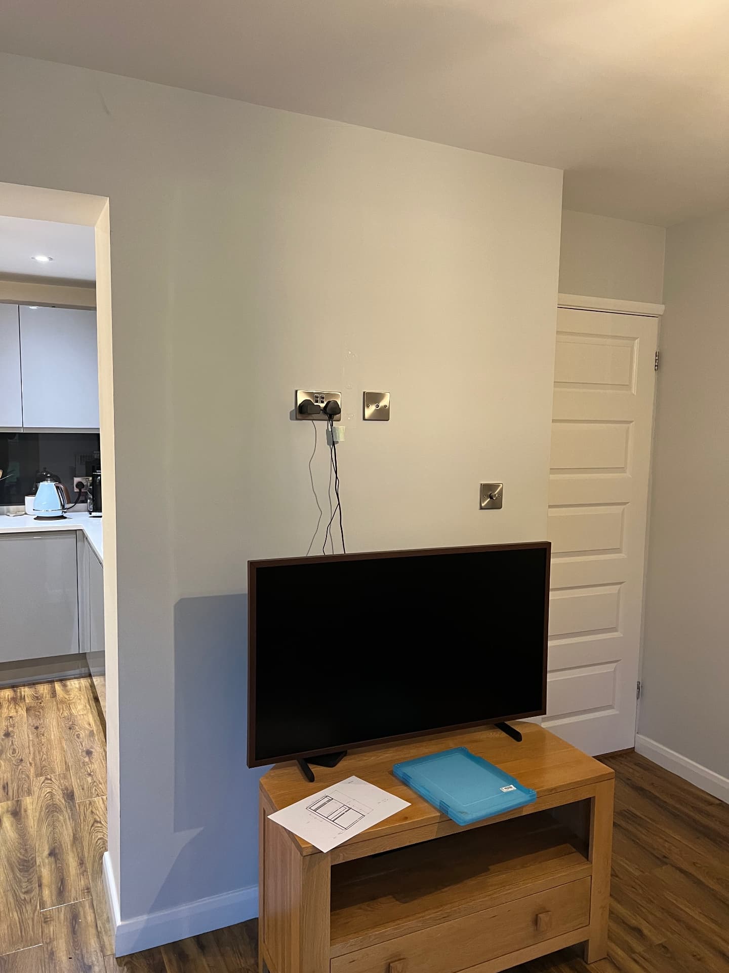 Bare snug wall with freestanding TV and trailing cables before the build