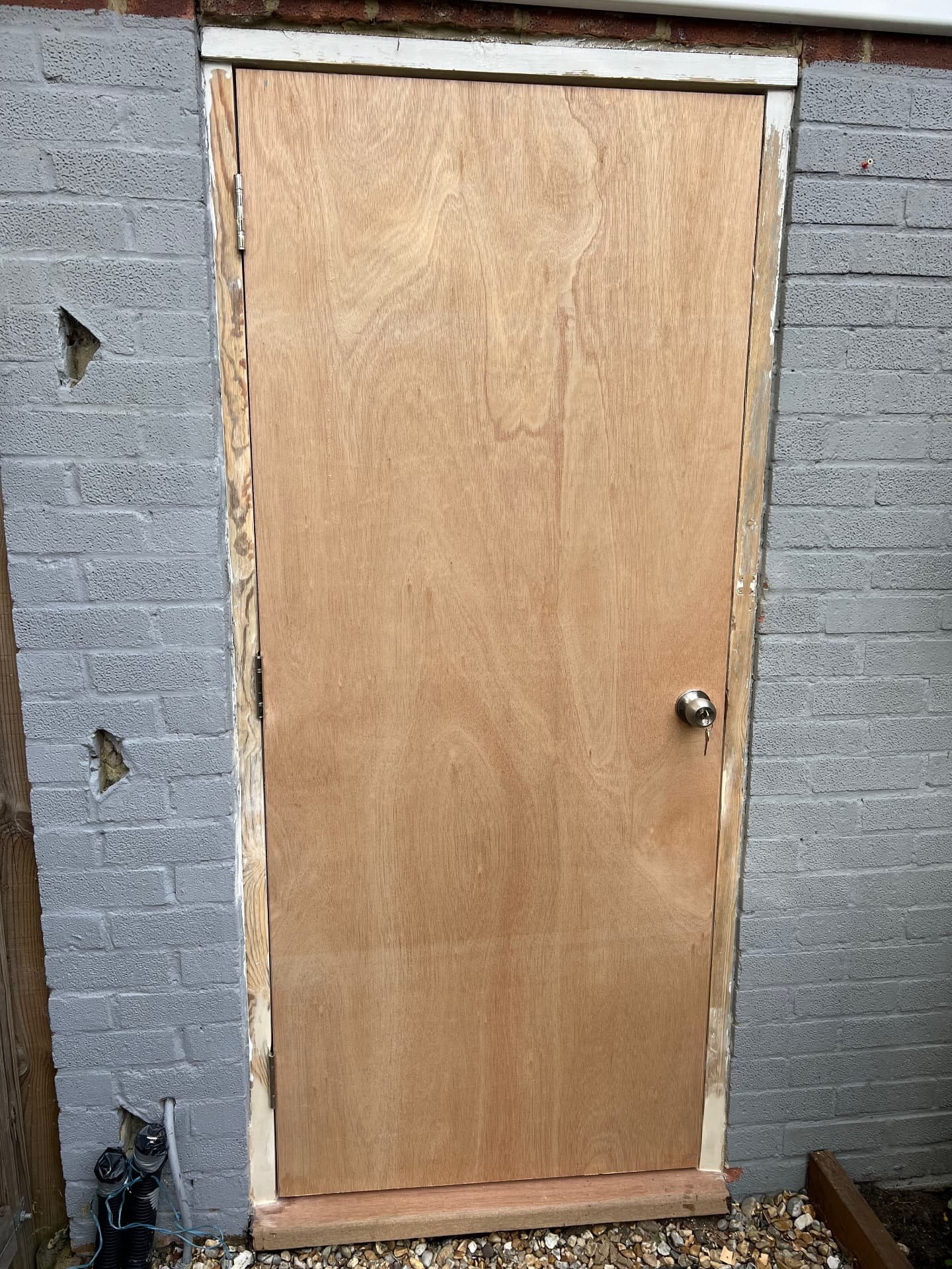 New exterior door fitted in a repaired frame with a hardwood threshold